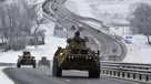 A convoy of Russian armored vehicles moves along a highway in Crimea, Tuesday, Jan. 18, 2022.