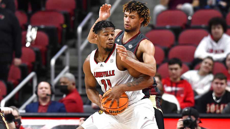 Louisville forward Sydney Curry (21) tries to get past Boston College forward T.J. Bickerstaff during the first half of an NCAA college basketball game in Louisville, Ky., Wednesday, Jan. 19, 2022. (AP Photo/Timothy D. Easley)