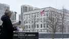 A woman walks past the U.S. Embassy in Kyiv, Ukraine, Monday, Jan. 24, 2022. 