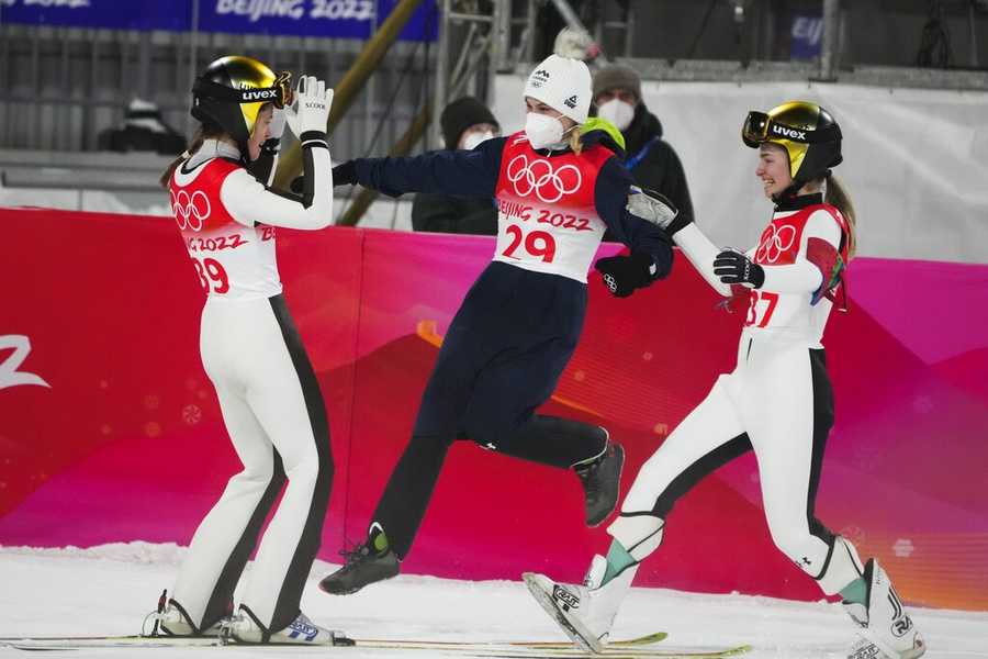 Jumping for gold Ursa Bogataj, of Slovenia, left, celebrates with teammates Spela Rogelj, center, Nika Kriznar, after winning gold at the 2022 Winter Olympics, Saturday, Feb. 5, 2022, in Zhangjiakou, China. (AP Photo/Matthias Schrader)