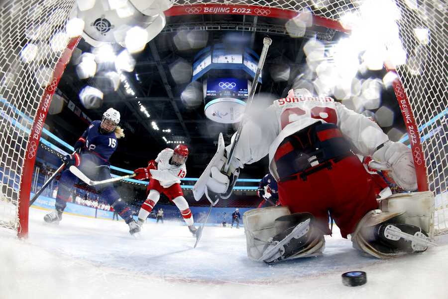 Shut-out shot Team USA's Savannah Harmon (15) scores a goal against Russian Olympic Committee goalkeeper Maria Sorokina, right, during a preliminary round women's hockey game at the 2022 Winter Olympics, Saturday, Feb. 5, 2022, in Beijing. (Song Yanhua/Pool Photo via AP)