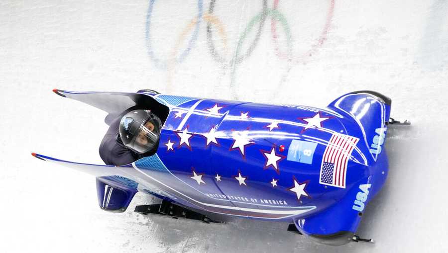 Elana Meyers Taylor and Sylvia Hoffman, of the United States, slide during the women's bobsled heat 3 at the 2022 Winter Olympics, Saturday, Feb. 19, 2022, in the Yanqing district of Beijing. (AP Photo/Mark Schiefelbein)