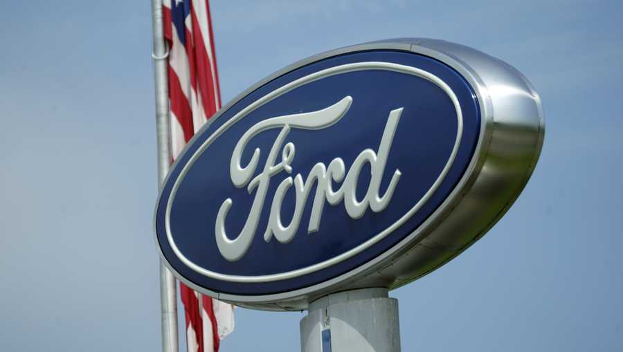 A Ford logo is seen on signage at Country Ford in Graham, N.C., Tuesday, July 27, 2021. Ford is recalling more than 330,000 Mustangs in the U.S., Wednesday, Feb. 23, 2022, to fix backup camera displays that go blank or become distorted. The recall covers cars from the 2015 to 2017 model years.  (AP Photo/Gerry Broome)