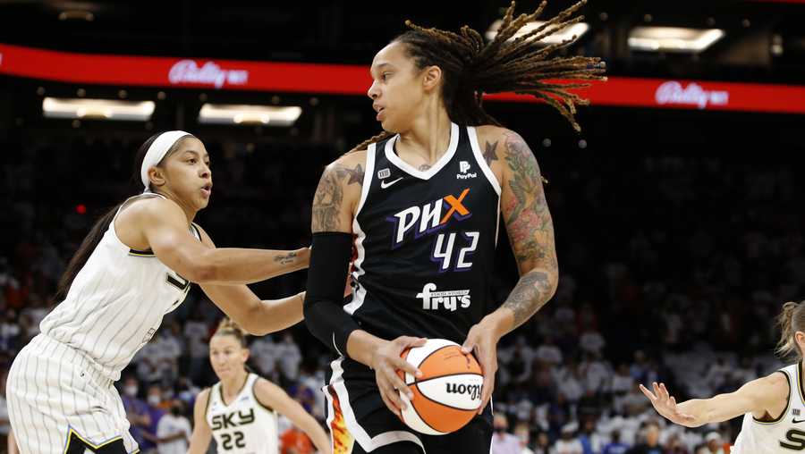 FILE - Phoenix Mercury center Brittney Griner (42) looks to pass as Chicago Sky center Candace Parker defends during the first half of game 1 of the WNBA basketball Finals , Sunday, Oct. 10, 2021, in Phoenix.   Griner was arrested in Russia last month at a Moscow airport after a search of her luggage revealed vape cartridges. The Russian Customs Service said Saturday, March 5, 2022,  that the cartridges were identified as containing oil derived from cannabis, which could carry a maximum penalty of 10 years in prison. The customs service identified the person arrested as a female player for the U.S. national team and did not specify the date of her arrest.
