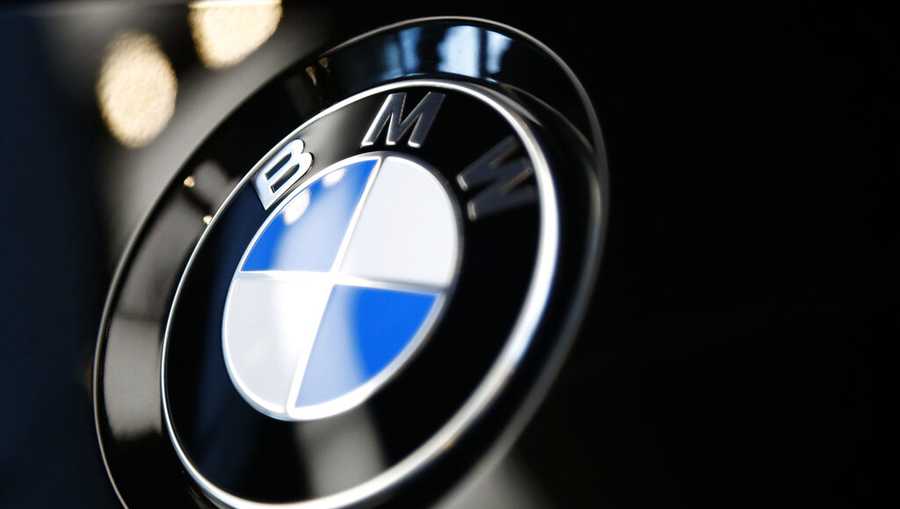 FILE- The logo of BMW is shown on a BMW car on March 20, 2019 in Munich, Germany. BMW is recalling more than 917,000 cars and SUVs in the U.S., Wednesday, March 9, 2022, most for a third time _ to fix a problem that can cause engine compartment fires. (AP Photo/Matthias Schrader)