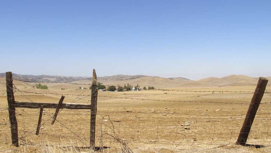FILE — A barbed wire fence runs along a ranch in Sites, Calif., on Friday, July 23, 2021. The Environmental Protection Agency, on Thursday, March 17, 2022, signaled its intent to loan nearly $2.2 billion to the Sites Project Authority to cover about half the cost of construction of the reservoir that would be used to store water during wet years for use during droughts. (AP Photo/Adam Beam, File )