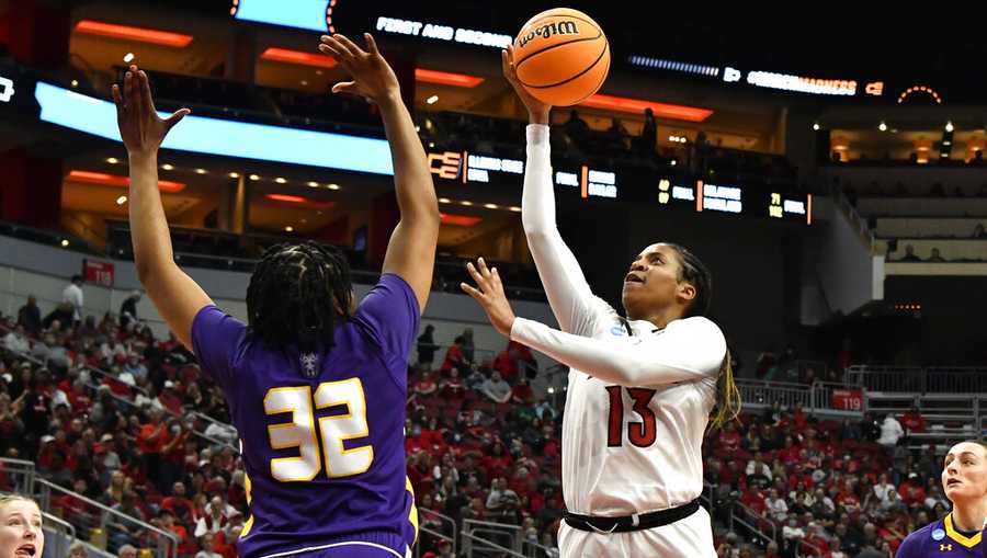 Louisville guard Merissah Russell (13) goes up for a shot over Albany forward Abby Robinson (32) during the second half of their women&apos;s NCAA Tournament college basketball first round game in Louisville, Ky., Friday, March 18, 2022. Louisville won 83-51. (AP Photo/Timothy D. Easley)