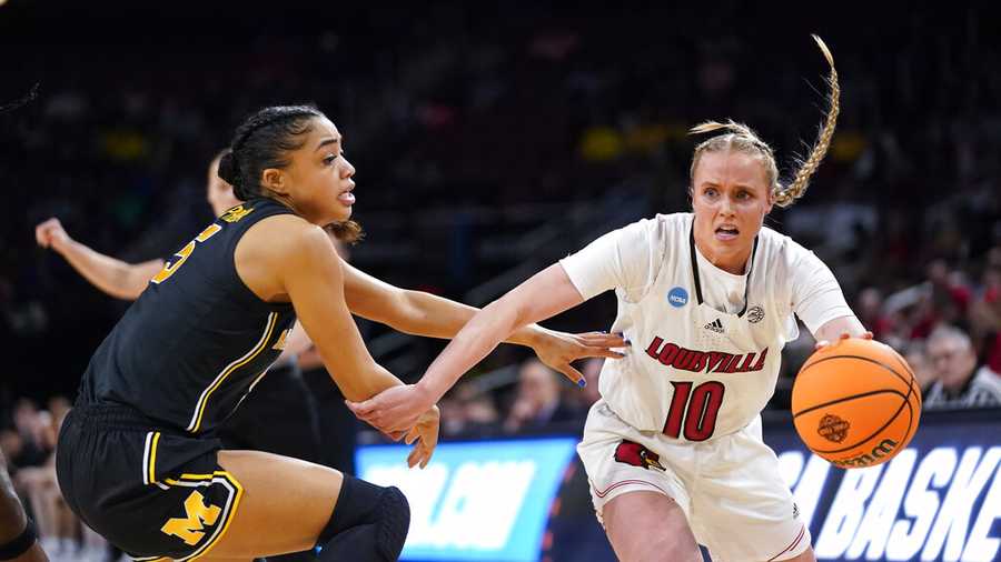 Louisville guard Hailey Van Lith (10) drives on Michigan guard Laila Phelia (5) during the first half of a college basketball game in the Elite 8 round of the NCAA women's tournament Monday, March 28, 2022, in Wichita, Kan. (AP Photo/Jeff Roberson)