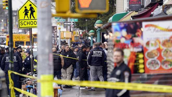New York City Police Department staff gather at the subway entrance. x20; stop in Brooklyn borough of New York, Tuesday, April 12, x20; 2022. Five people were shot dead Tuesday morning at a subway station n x20; Brooklyn, New York, law enforcement sources said.