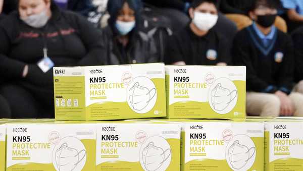 FILE - Boxes of KN95 protective masks are stacked together before being distributed to students at Camden High School in Camden, N.J., Wednesday, Feb. 9, 2022. (AP Photo/Matt Rourke, File)