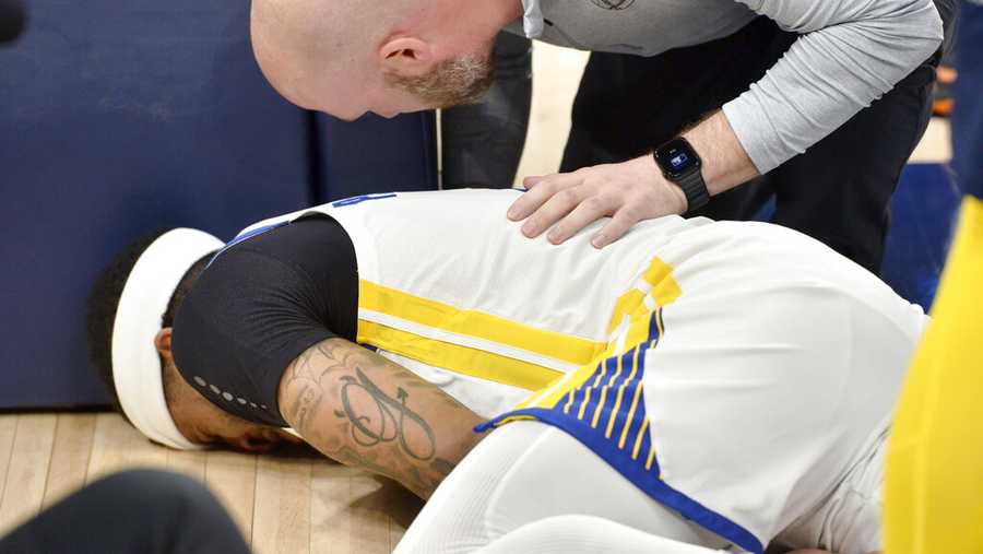 Golden State Warriors guard Gary Payton II lies on the court in the first half during Game 2 of a second-round NBA basketball playoff series against the Memphis Grizzlies Tuesday, May 3, 2022, in Memphis, Tenn. (AP Photo/Brandon Dill)