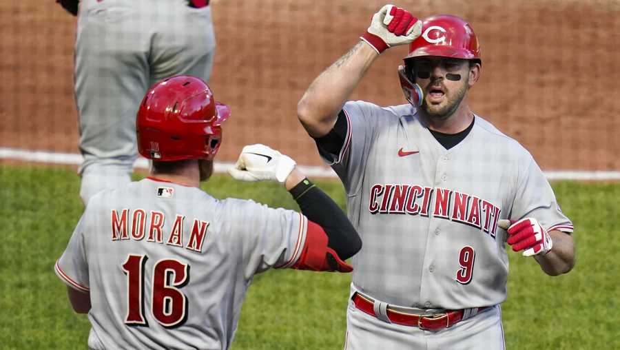 Cincinnati Reds' Mike Moustakas (9) celebrates with Colin Moran (16) after hitting a solo home run against the Pittsburgh Pirates during the third inning of a baseball game, Friday, May 13, 2022, in Pittsburgh. (AP Photo/Keith Srakocic)