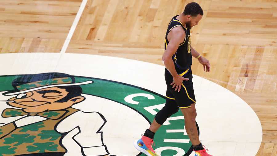 Golden State Warriors guard Stephen Curry (30) reacts as he walks down the court against the Boston Celtics during the third quarter of Game 3 of basketball&apos;s NBA Finals, Wednesday, June 8, 2022, in Boston. (AP Photo/Michael Dwyer)