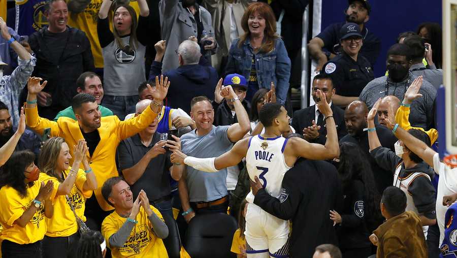 Golden State Warriors guard Jordan Poole (3) celebrates with fans after scoring against the Boston Celtics during the second half of Game 5 of basketball&apos;s NBA Finals in San Francisco, Monday, June 13, 2022. (AP Photo/John Hefti)