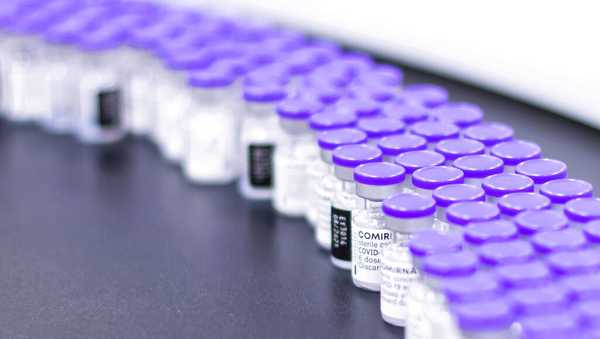 FILE - In this March 2021 photo provided by Pfizer, vials of the Pfizer-BioNTech COVID-19 vaccine are prepared for packaging at the company's facility in Puurs, Belgium. (Pfizer via AP)