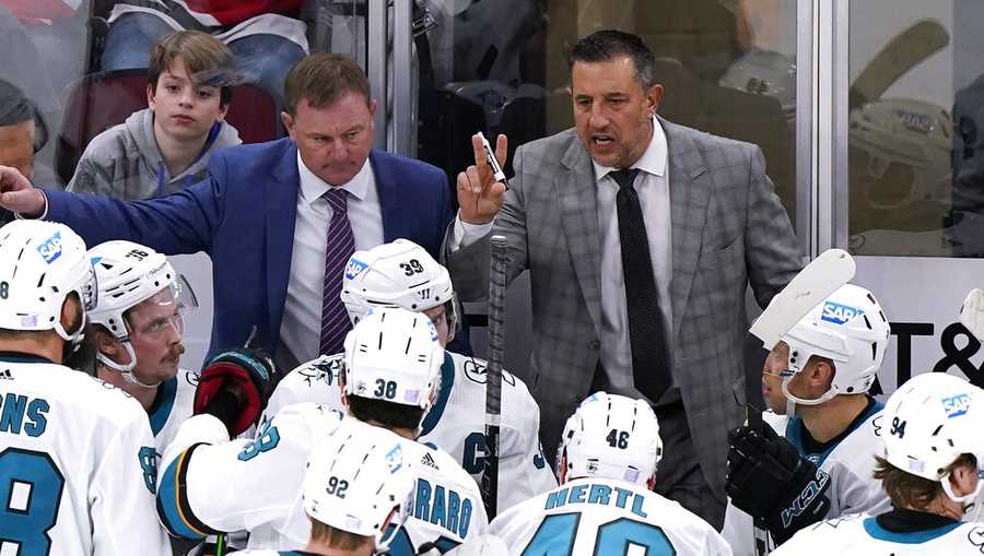 FILE - San Jose Sharks head coach Bob Boughner, top right, talks to his team as assistant John Madden, left, looks on during the third period of an NHL hockey game against the Chicago Blackhawks in Chicago, Sunday, Nov. 28, 2021. The San Jose Sharks have abruptly fired coach Bob Boughner and his staff two months after the regular season ended. The team confirmed the moves Friday, July 1, 2022, after reports surfaced Boughner and assistants John MacLean and John Madden were informed Thursday night they were being let go. (AP Photo/Nam Y. Huh, File)
