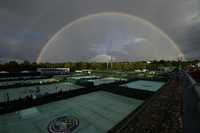 A rainbow arches in the sky as seen from the courts on day four of the Wimbledon tennis championships in London, Thursday, June 30, 2022.