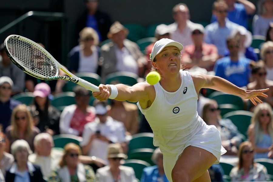 Wimbledon Tennis Week One Photo Gallery Poland's Iga Swiatek returns to Croatia's Jana Fett in a first round women's singles match on day two of the Wimbledon tennis championships in London, Tuesday, June 28, 2022.