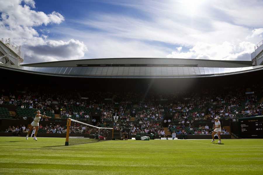 Wimbledon Tennis Week One Photo Gallery Karolina Muchova of the Czech Republic, left, returns the ball to Romania's Simona Halep in a singles tennis match on day two of the Wimbledon tennis championships in London, Tuesday, June 28, 2022.