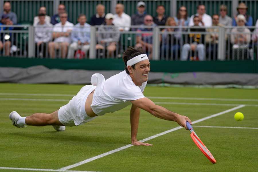 Wimbledon Tennis Week One Photo Gallery Taylor Fritz of the US stretches to return to Britain's Alastair Gray in a second round men's single match on day four of the Wimbledon tennis championships in London, Thursday, June 30, 2022.