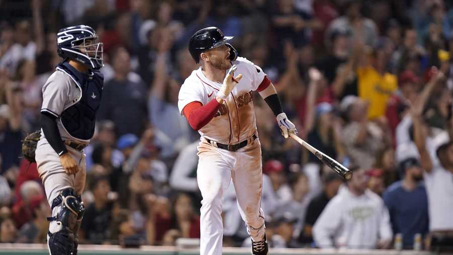 Boston Red Sox's Trevor Story, right, hits a three-run double as New York Yankees'; Jose Trevino, left, looks on in the seventh inning of a baseball game, Sunday, July 10, 2022, in Boston. The Red Sox won 11-6. (AP Photo/Steven Senne)