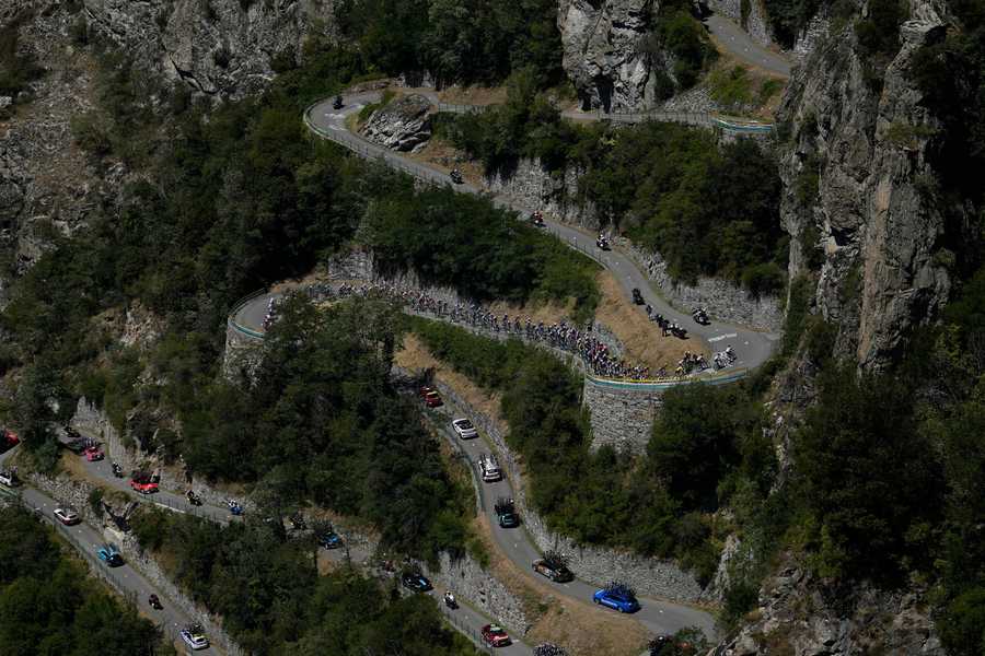 The pack climbs Lacets de Montvernier during the eleventh stage of the Tour de France cycling race over 152 kilometers (94.4 miles) with start in Albertville and finish in Col du Granon Serre Chevalier, France, Wednesday, July 13, 2022.
