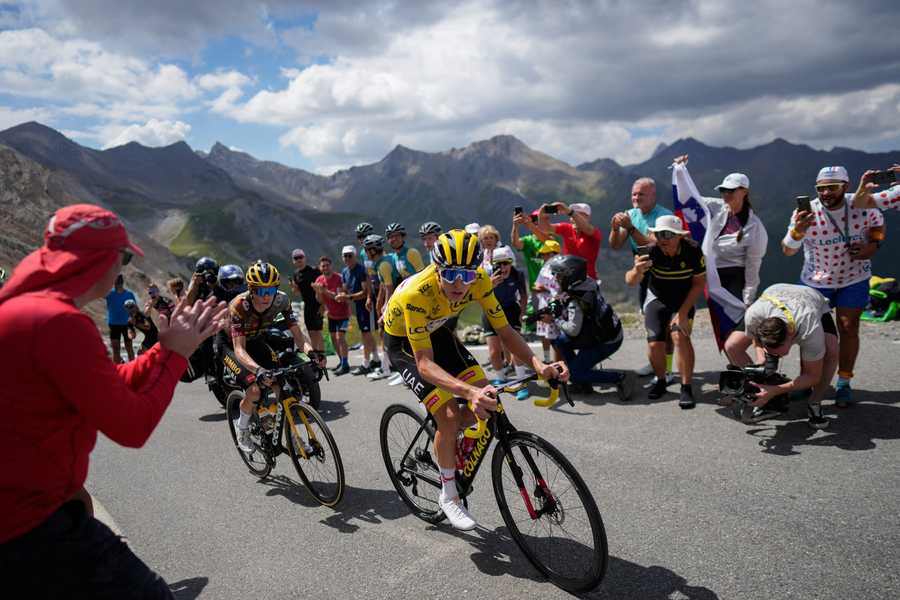 Stage winner and new overall leader Denmark's Jonas Vingegaard, left, and Slovenia's Tadej Pogacar, wearing the overall leader's yellow jersey, climb during the eleventh stage of the Tour de France cycling race over 152 kilometers (94.4 miles) with start in Albertville and finish in Col du Granon Serre Chevalier, France, Wednesday, July 13, 2022.