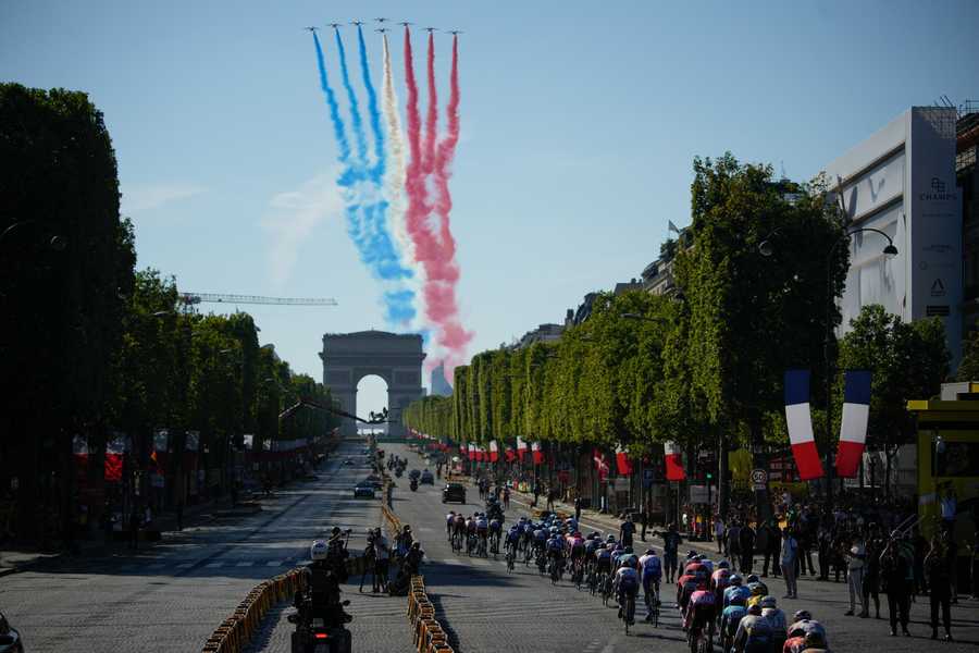 Alphajets of the Patrouille de France fly over the Arc de Triomphe and Champs Elysees as the riders pass during the twenty-first stage of the Tour de France cycling race over 116 kilometers (72 miles) with start in Paris la Defense Arena and finish on the Champs Elysees in Paris, France, Sunday, July 24, 2022.