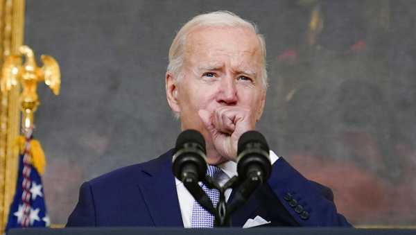 FILE - President Joe Biden coughs as he speaks about 