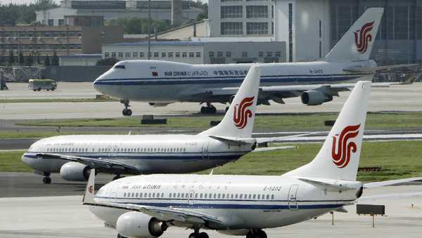 FILE - Air China planes sit on the tarmac at Beijing Airport in Beijing, China on Aug. 20, 2009. The U.S. government is suspending 26 flights by Chinese airlines from the United States to China in a dispute over anti-virus controls after Beijing suspended flights by American carriers. (AP Photo/Greg Baker, File)