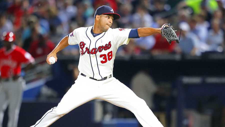 FILE - Atlanta Braves relief pitcher Anthony Varvaro delivers in the sixth inning of a baseball game against the Los Angeles Angels on June 15, 2014, in Atlanta. Varvaro, a former MLB pitcher who retired in 2016 to become a police officer in the New York City area, was killed in a car accident Sunday, Sept. 11, 2022, on his way to work at the Sept. 11 memorial ceremony in Manhattan, according to police officials and his former teams. (AP Photo/Todd Kirkland, File)
