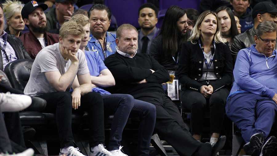 FILE - Phoenix Suns owner Robert Sarver, center, watches during the second half of an NBA basketball game against the Minnesota Timberwolves, Saturday, Dec. 15, 2018, in Phoenix. The NBA has suspended Phoenix Suns and Phoenix Mercury owner Robert Sarver for one year, plus fined him $10 million, after an investigation found that he had engaged in what the league called “workplace misconduct and organizational deficiencies." The findings of the league&apos;s report, published Tuesday, Sept. 13, 2022, came nearly a year after the NBA asked a law firm to investigate allegations that Sarver had a history of racist, misogynistic and hostile incidents over his nearly two-decade tenure overseeing the franchise. (AP Photo/Ralph Freso, File)