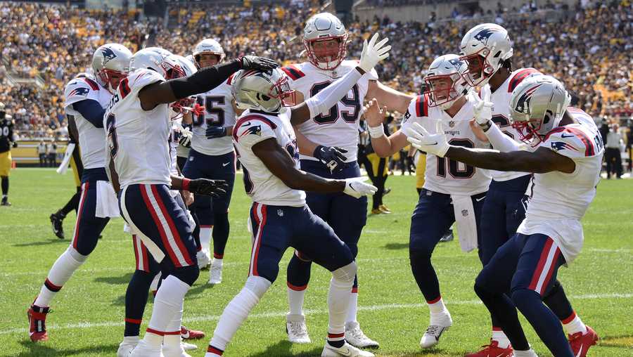 New England Patriots wide receiver Nelson Agholor, center, celebrates after taking a 44-yard pass play for a touchdown during the first half of an NFL football game against the Pittsburgh Steeler in Pittsburgh, Sunday, Sept. 18, 2022. (AP Photo/Don Wright)
