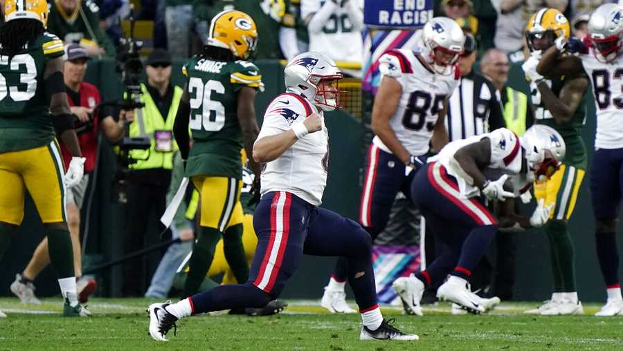 New England Patriots quarterback Bailey Zappe celebrates after a touchdown run by teammate Damien Harris during the second half of an NFL football game against the Green Bay Packers, Sunday, Oct. 2, 2022, in Green Bay, Wis. (AP Photo/Morry Gash)