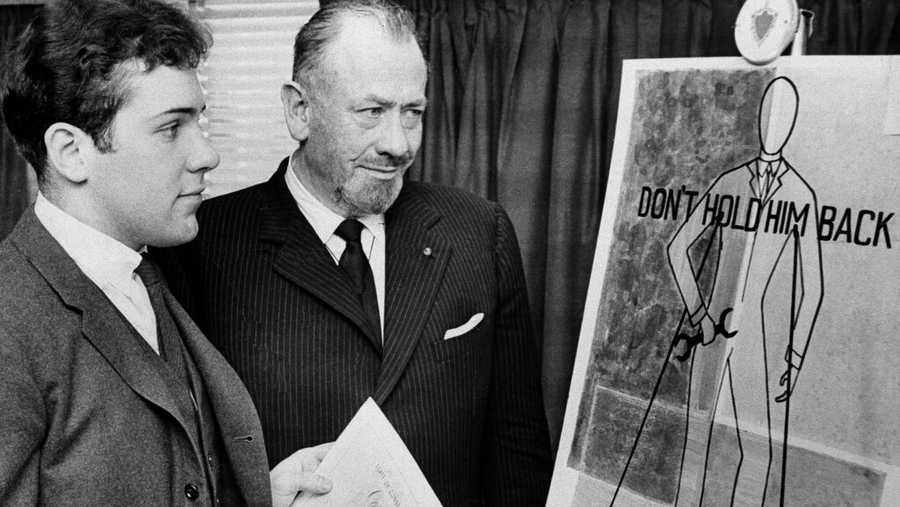 FILE — Nobel prize-winning author John Steinbeck, right, admires a prize-winning poster by his son, Thomas Steinbeck, in Hartford, Conn., March 22, 1963. A tender and touching letter that author John Steinbeck penned to his teenage son, offering fatherly advice after the young man confided that he was in love for the first time, is going up for auction. "If you are in love — that&apos;s a good thing — that&apos;s about the best thing that can happen to anyone. Don&apos;t let anyone make it small or light to you," the Nobel literature laureate told his son, Thomas, in 1958. (AP Photo, File)