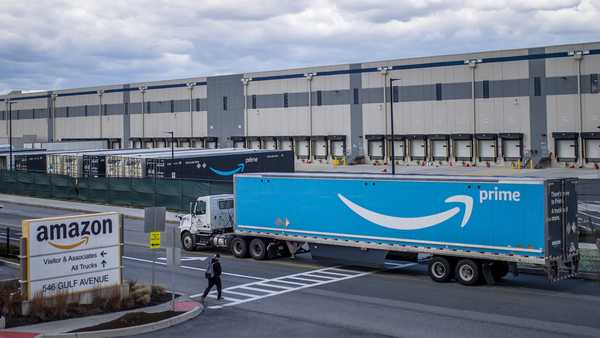 FILE - A truck arrives at the Amazon warehouse facility, in the Staten Island borough of New York, April 1, 2022. Amazon will hire 150,000 full-time, part-time and seasonal employees across its warehouses ahead of the holiday season.  The announcement, made Thursday, Oct. 6, shows the e-commerce behemoth is taking a less conservative approach to its holiday planning than Walmart.