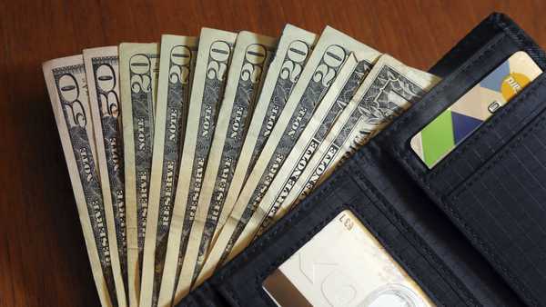 FILE - In this June 15, 2018, file photo, cash is fanned out from a wallet in North Andover, Mass. A personal loan can be a good option when you need money, but it typically requires strong credit and high income to qualify. What if you don't meet the requirements for a personal loan? Consider several alternative ways to get money, such as family loans and cash advances.   (AP Photo/Elise Amendola, File)