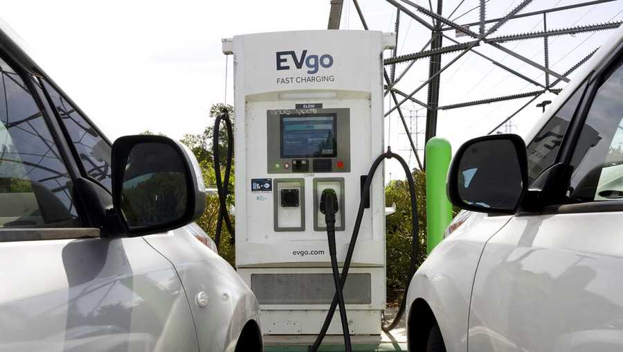 FILE - Electric cars are parked at a charging station in Sacramento, Calif., Wednesday, April 13, 2022. Proposition 30, which has has divided Democrats, would add a tax on the highest earners, with most of the money going toward building charging stations and helping people buy electric cars. (AP Photo/Rich Pedroncelli, File)