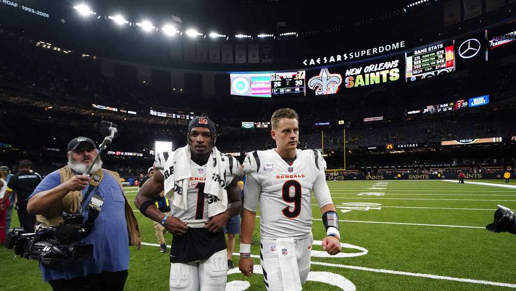 Cincinnati Bengals quarterback Joe Burrow (9) walks to the sidelines during  an NFL football gam …