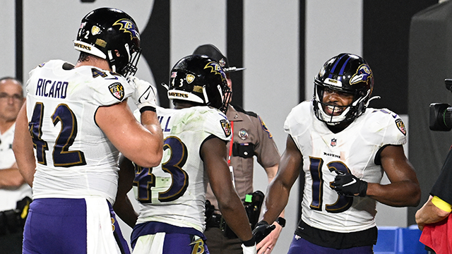 baltimore ravens wide receiver devin duvernay is congratulated by justice hill (43) and patrick ricard (42) after scoring during the second half of an nfl football game against the tampa bay buccaneers thursday, oct. 27, 2022, in tampa, fla.
