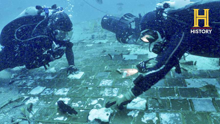 In this photo provided by the HISTORY® Channel, underwater explorer and marine biologist Mike Barnette and wreck diver Jimmy Gadomski explore a 20-foot segment of the 1986 Space Shuttle Challenger that the team discovered in the waters off the coast of Florida during the filming of The HISTORY® Channel’s new series, “The Bermuda Triangle: Into Cursed Waters,” premiering Tuesday, Nov. 22, 2022. (The HISTORY® Channel via AP)