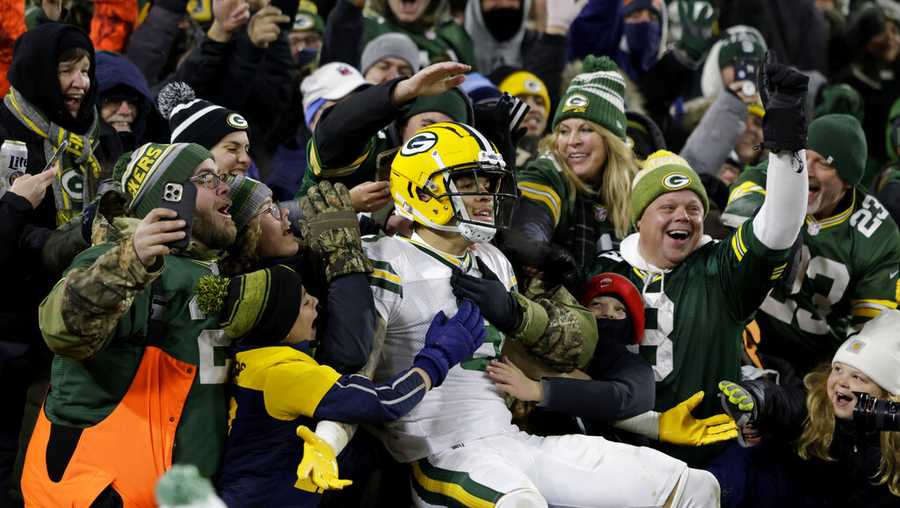 Green Bay Packers wide receiver Christian Watson (9) celebrates with fans after catching a touchdown pass during the second half of an NFL football game agains the Tennessee Titans Thursday, Nov. 17, 2022, in Green Bay, Wis. (AP Photo/Matt Ludtke)