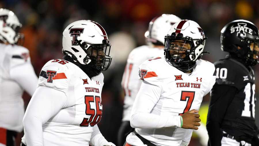 Texas Tech quarterback Donovan Smith (7) celebrates with teammate offensive lineman Dennis Wilburn (56) after scoring on a 1-yard touchdown run in the first half of an NCAA college football game against Iowa State, Saturday, Nov. 19, 2022, in Ames, Iowa. (AP Photo/Charlie Neibergall)