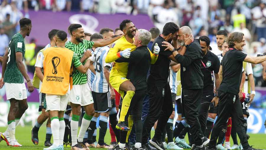Saudi Arabia&apos;s goalkeeper Mohammed Al-Owais celebrates with his team after winning the World Cup group C soccer match between Argentina and Saudi Arabia at the Lusail Stadium in Lusail, Qatar, Tuesday, Nov. 22, 2022. (AP Photo/Natacha Pisarenko)