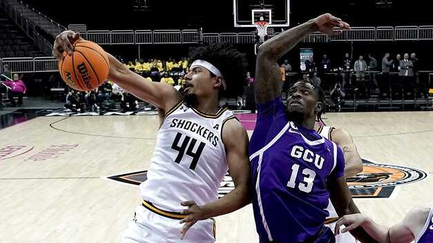 Wichita State forward Isaiah Poor Bear-Chandler (44) beats Grand Canyon forward Aidan Igiehon (13) to a rebound during the first half of an NCAA college basketball game in the Hall of Fame Classic, Monday, Nov. 21, 2022, in Kansas City, Mo. (AP Photo/Charlie Riedel)