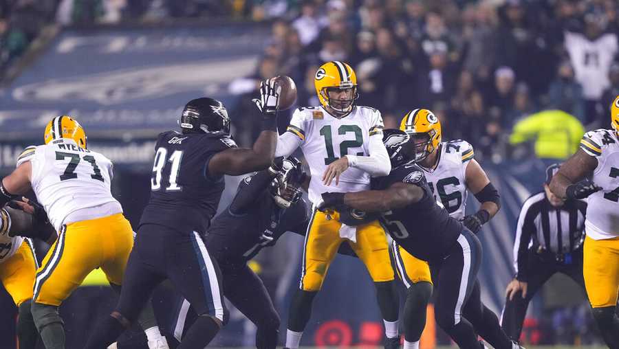 Green Bay Packers quarterback Aaron Rodgers (12) is hit during the second half of an NFL football game against the Philadelphia Eagles, Sunday, Nov. 27, 2022, in Philadelphia. (AP Photo/Matt Rourke)