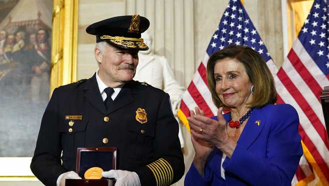 Speaker&#x20;of&#x20;the&#x20;House&#x20;Nancy&#x20;Pelosi&#x20;of&#x20;Calif.,&#x20;applauds&#x20;U.S.&#x20;Capitol&#x20;Police&#x20;Chief&#x20;J.&#x20;Thomas&#x20;Manger,&#x20;during&#x20;a&#x20;Congressional&#x20;Gold&#x20;Medal&#x20;ceremony&#x20;honoring&#x20;law&#x20;enforcement&#x20;officers&#x20;who&#x20;defended&#x20;the&#x20;U.S.&#x20;Capitol&#x20;on&#x20;Jan.&#x20;6,&#x20;2021,&#x20;in&#x20;the&#x20;U.S.&#x20;Capitol&#x20;Rotunda&#x20;in&#x20;Washington,&#x20;Tuesday,&#x20;Dec.&#x20;6,&#x20;2022.&#x20;&#x28;AP&#x20;Photo&#x2F;Alex&#x20;Brandon&#x29;