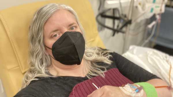 This photo provided by Amy Watson of Portland, Ore., shows her during an iron infusion in December 2022. Watson, approaching 50, says she has 