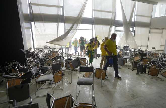 Protesters,&#x20;supporters&#x20;of&#x20;Brazil&#x27;s&#x20;former&#x20;President&#x20;Jair&#x20;Bolsonaro,&#x20;storm&#x20;the&#x20;National&#x20;Congress&#x20;building&#x20;in&#x20;Brasilia,&#x20;Brazil,&#x20;Sunday,&#x20;Jan.&#x20;8,&#x20;2023.&#x20;&#x28;AP&#x20;Photo&#x2F;Eraldo&#x20;Peres&#x29;