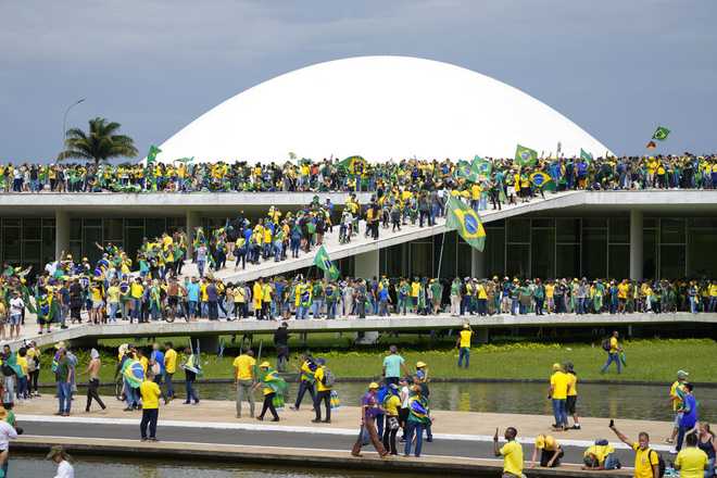 Protesters,&#x20;supporters&#x20;of&#x20;Brazil&#x27;s&#x20;former&#x20;President&#x20;Jair&#x20;Bolsonaro,&#x20;storm&#x20;the&#x20;National&#x20;Congress&#x20;building&#x20;in&#x20;Brasilia,&#x20;Brazil,&#x20;Sunday,&#x20;Jan.&#x20;8,&#x20;2023.&#x20;&#x28;AP&#x20;Photo&#x2F;Eraldo&#x20;Peres&#x29;